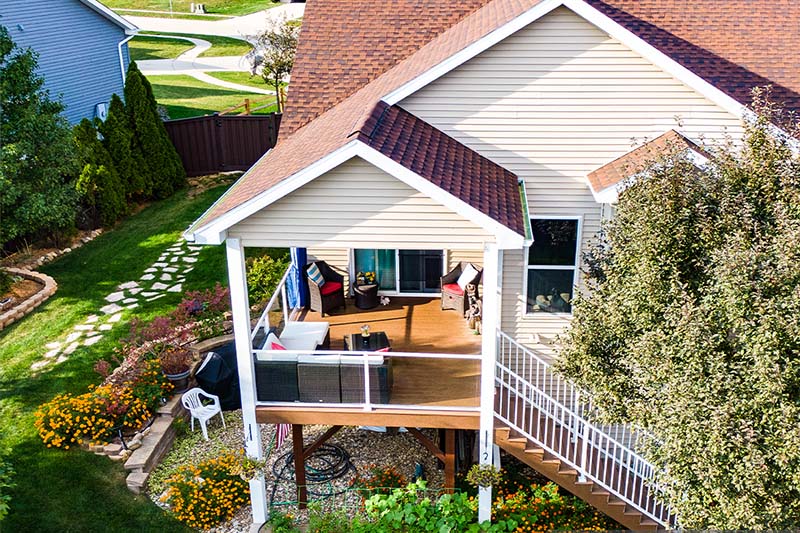 Modern Elevated Deck with Cedar Ceiling and Glass Railings in Cedar Falls